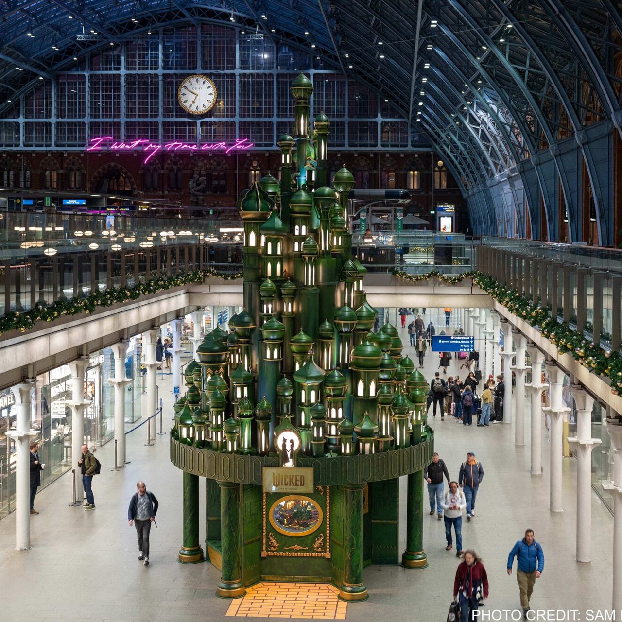 12 metre tall Christmas tree themed for the Wicked film on display at St Pancras International.